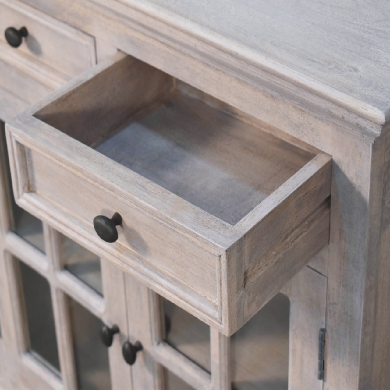 Open drawer view of The Alnwick Glazier’s Cabinet — showcasing stone finish wood texture, spacious interior, and metal handle detailing for soulful storage and timeless organisation.