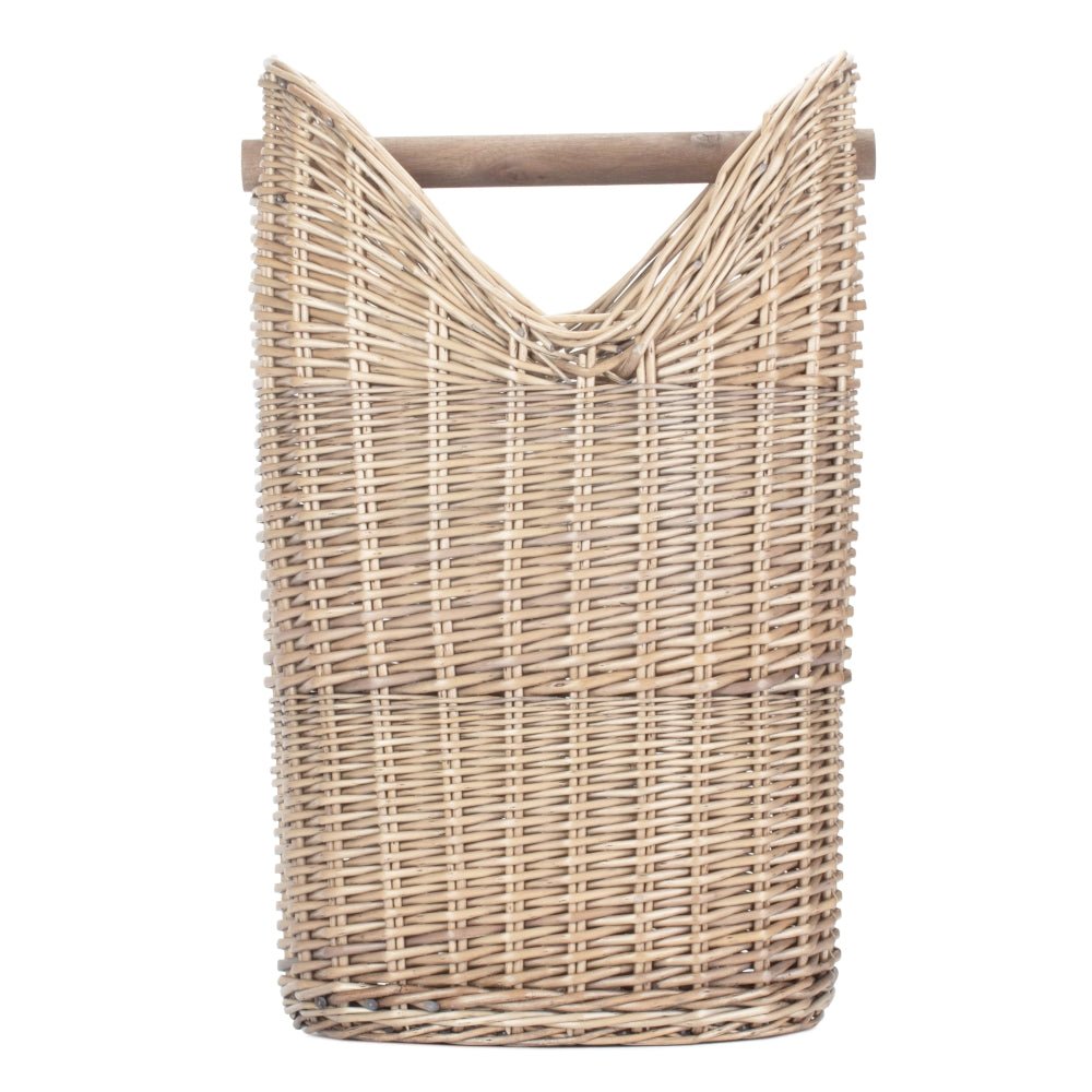 The Aldwych Loo Stand – round handwoven wicker toilet roll holder with antique wash finish, shown empty from the side to highlight its curved silhouette, spacious interior, and natural weave.