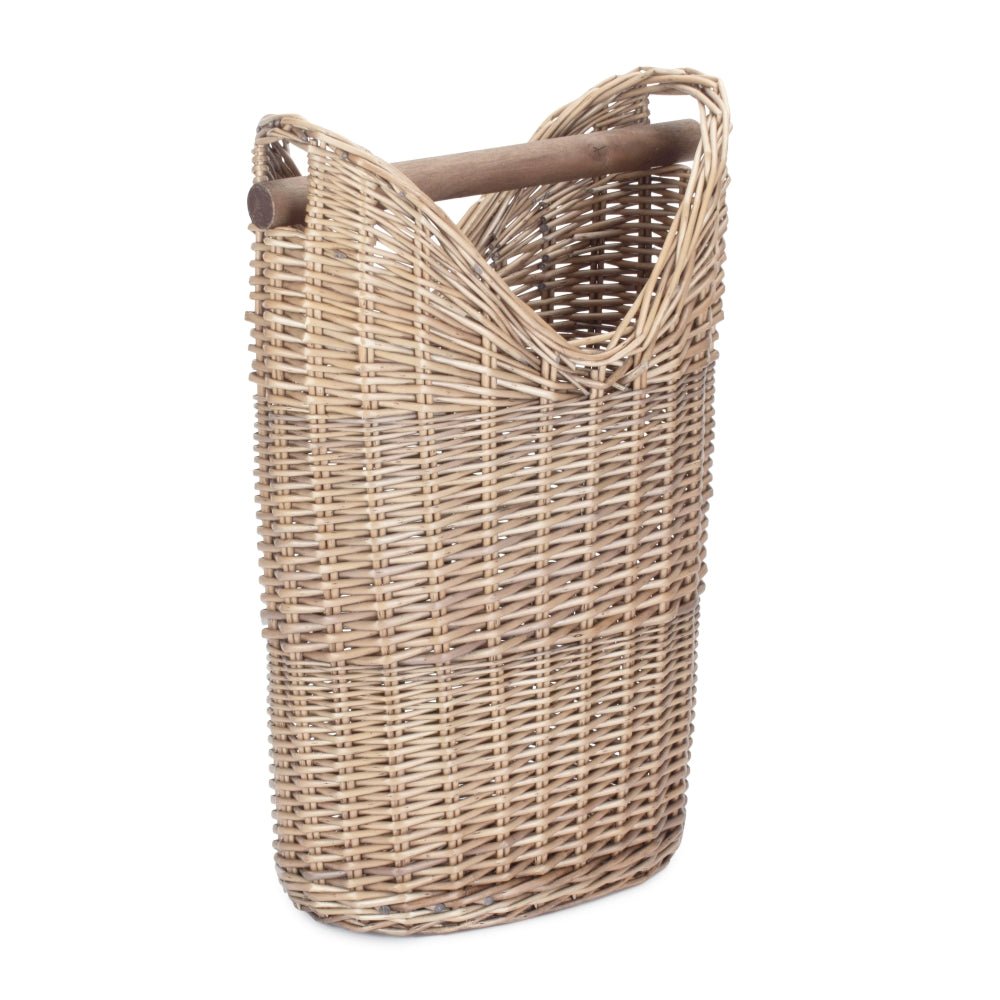 The Aldwych Loo Stand – handwoven round wicker toilet roll holder with antique wash finish, shown empty from the side to highlight its curved silhouette, natural weave, and spacious interior.