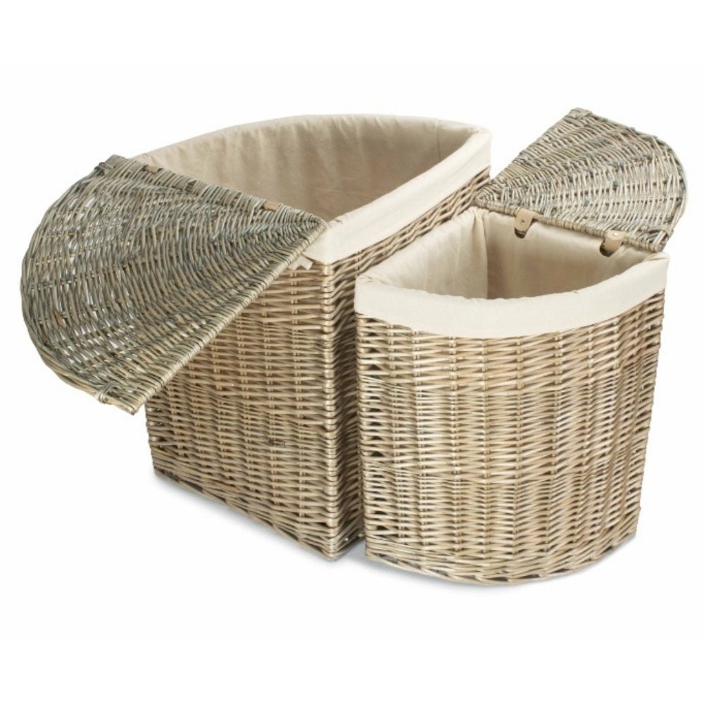 Both The Elmsmere Corner Keeper in  antique wash willow laundry baskets with removable white cotton lining, styled in a softly lit hallway corner.