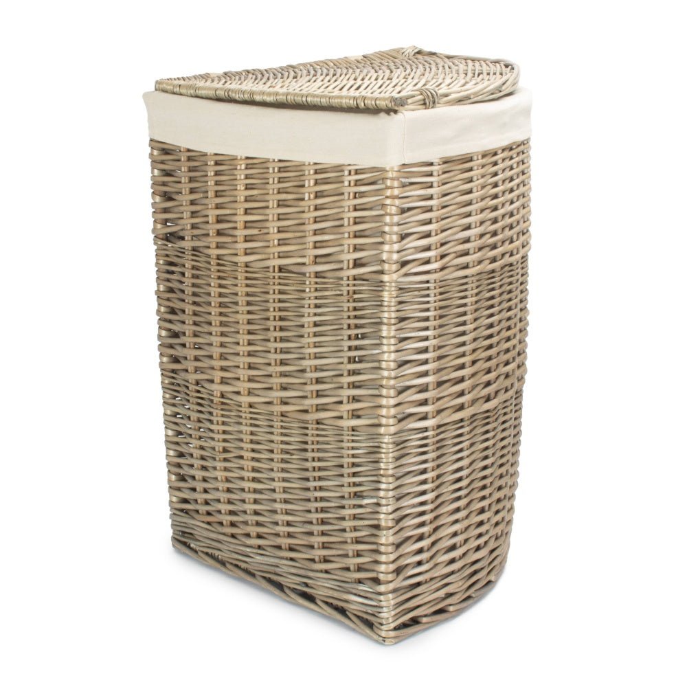 The Elmsmere Corner Keeper in large size – antique wash willow laundry basket with removable white cotton lining, styled on its own.