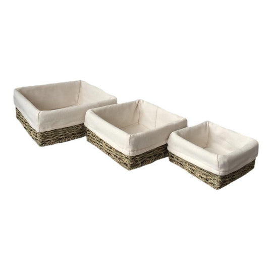 The Mersea Square Keepers – set of three handwoven square seagrass baskets with removable cotton linings, shown nested to highlight tiered sizing, natural weave, and soft interiors.