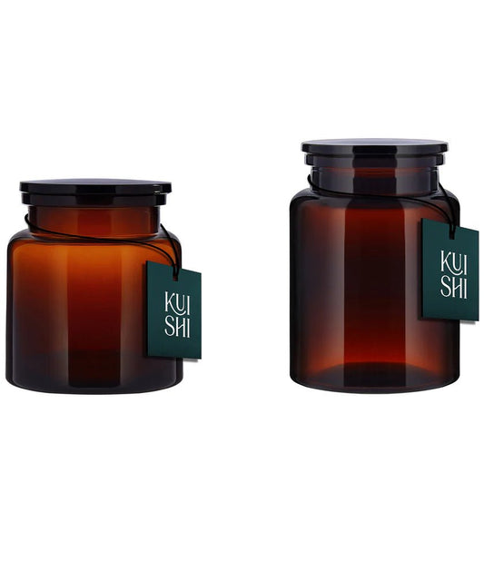 The Wetherby Amber Glass Storage Jar Duo – large and small apothecary-style jars in translucent amber glass with wide-mouth design, styled together for bath salts, cotton pads, or basin-side essentials.