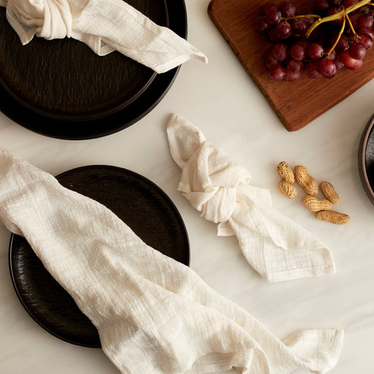 Alverley White cotton napkin set styled on a marble table with black ceramic plates and red grapes for poetic countryside dining and soulful table layering.