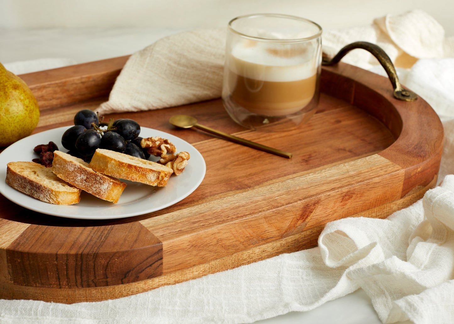 Close-up of The Branlow Hearth Tray showing warm fir wood grain and antique brass handles, rustic oval tray with heritage styling and soulful detai