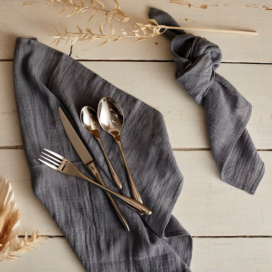 Branston silver stainless steel cutlery set resting on natural linen napkin—evokes timeless hosting, countryside charm, and refined everyday rituals.