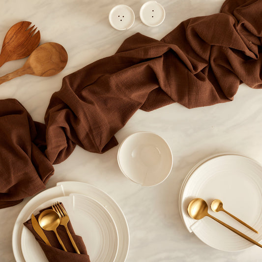 Branwell Brown gauze table runner in soft cotton, styled on a rustic table with gold cutlery and white ceramic tableware for heritage-inspired dining and soulful layering.