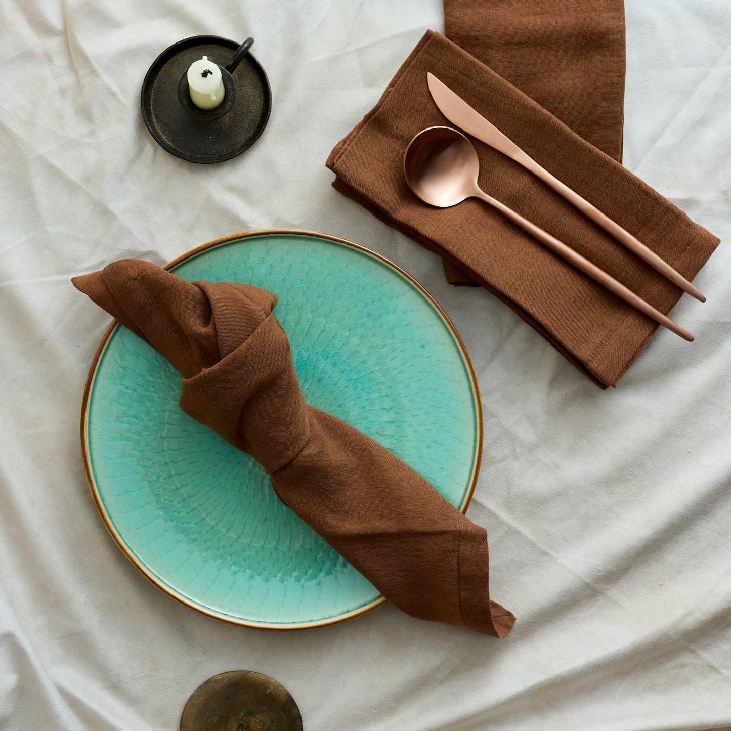 Branwell Brown muslin napkin set in soft cotton, styled on a rustic table with rose gold cutlery, jade pottery plate, and iron candlestick for soulful countryside gatherings and heritage-inspired charm.