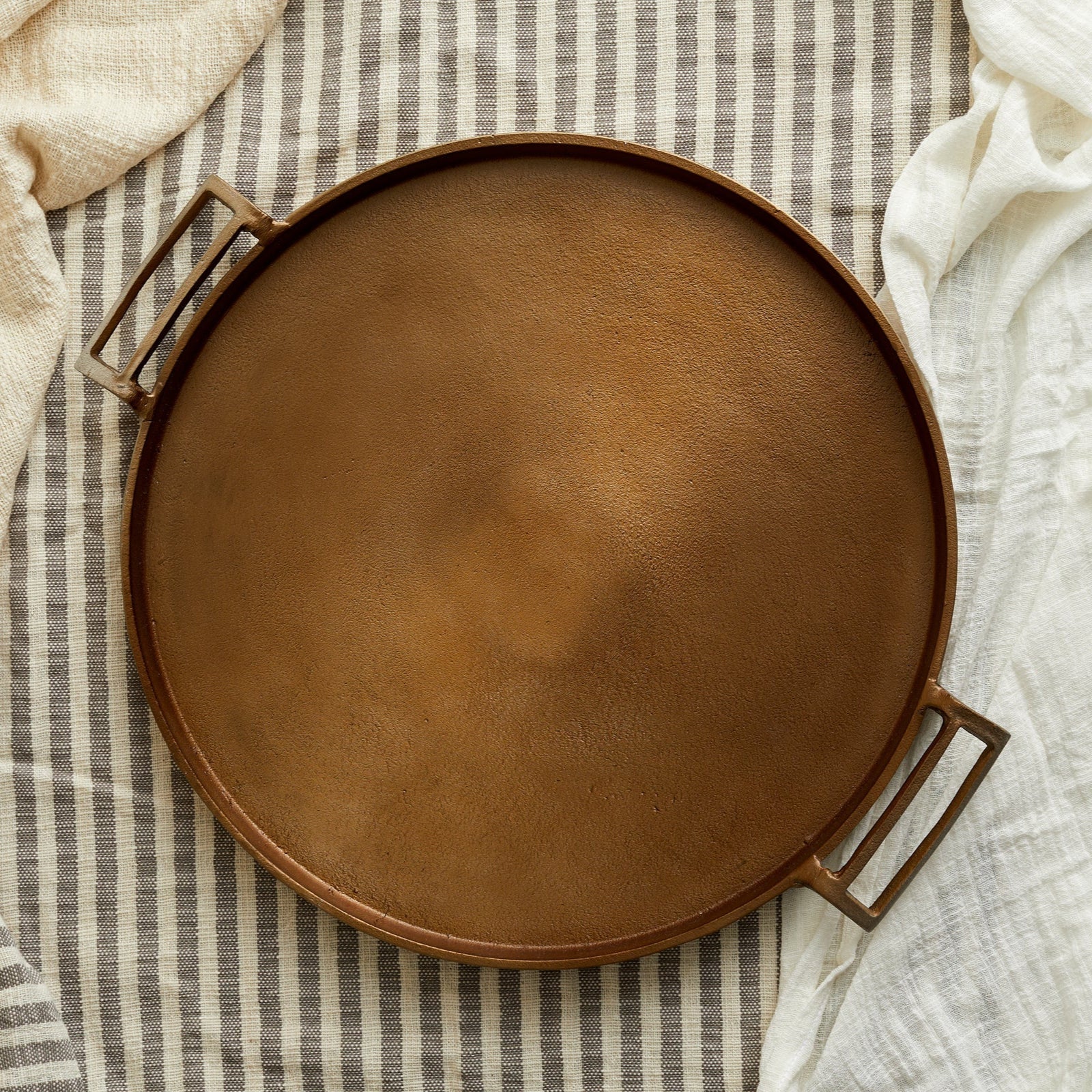 Brontë Bronze Round Tray by Timeless Trading Co. – handcrafted aluminium tray in warm bronze finish, rustic round style for soulful serveware and display