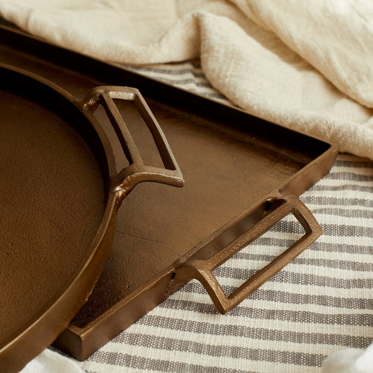 Brontë Bronze Round and Rectangular Tray edges – warm bronze aluminium with rustic finish, handcrafted detail, soulful styling by Timeless Trading Co.