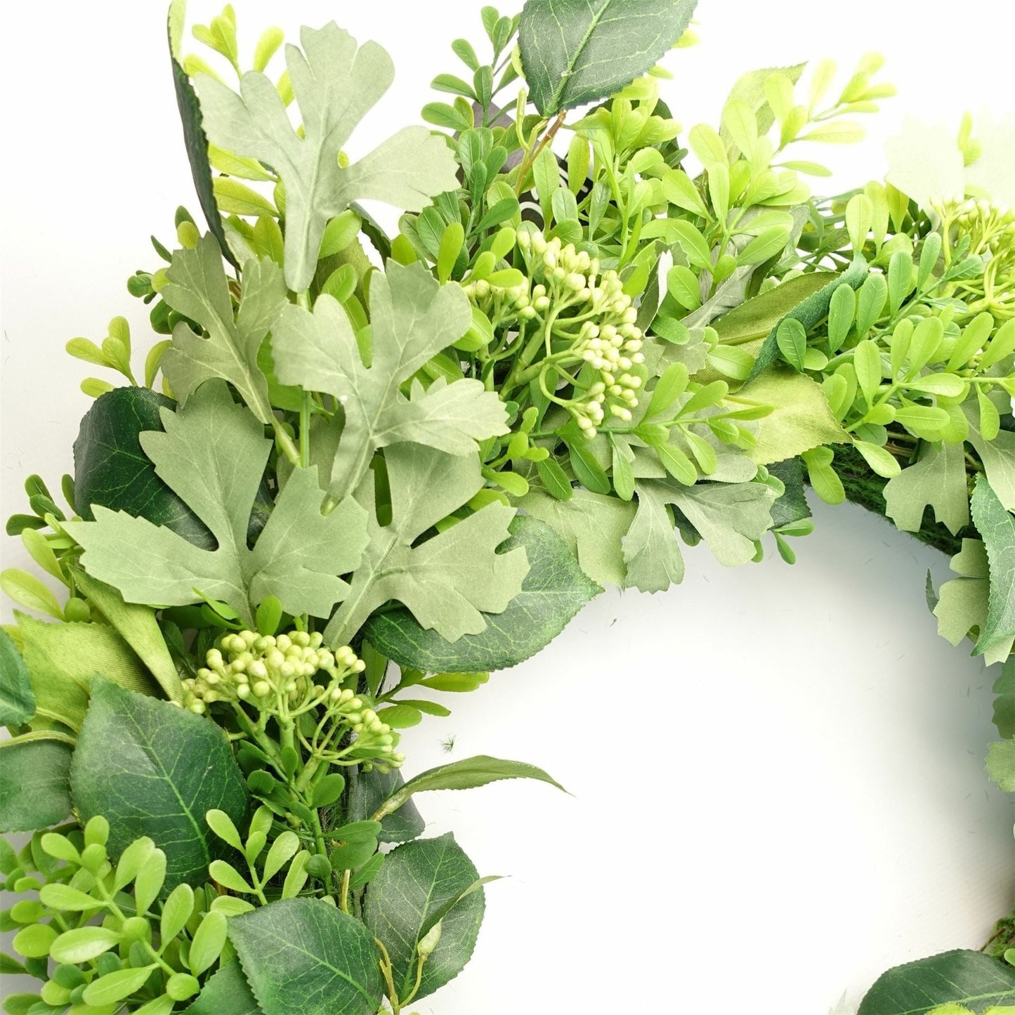 Detailed close-up of The Fern & Fable Wreath—layered green fern fronds with soft veining and natural woven base, styled for botanical texture and timeless countryside charm.