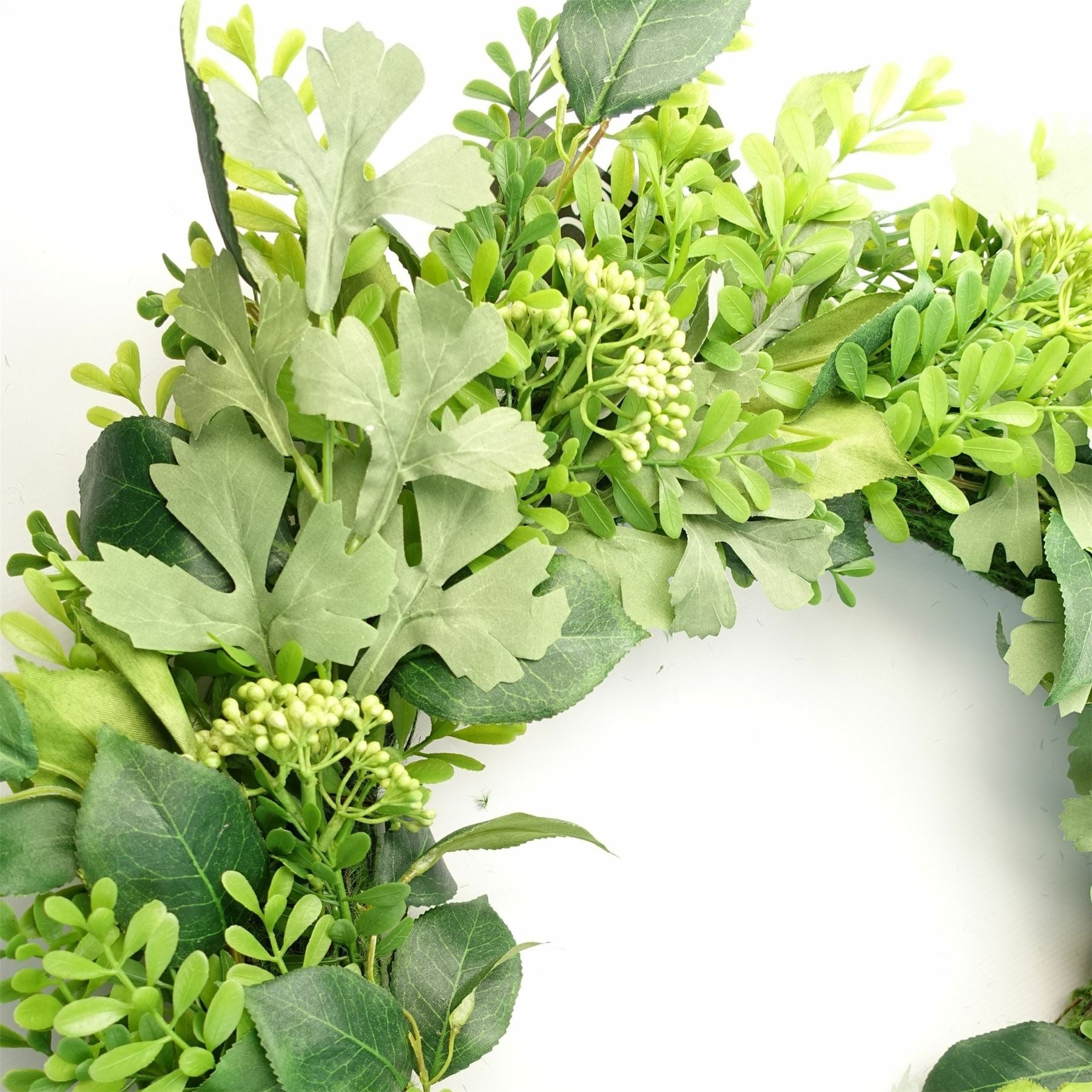 Detailed close-up of The Fern & Fable Wreath—layered green fern fronds with soft veining and natural woven base, styled for botanical texture and timeless countryside charm.