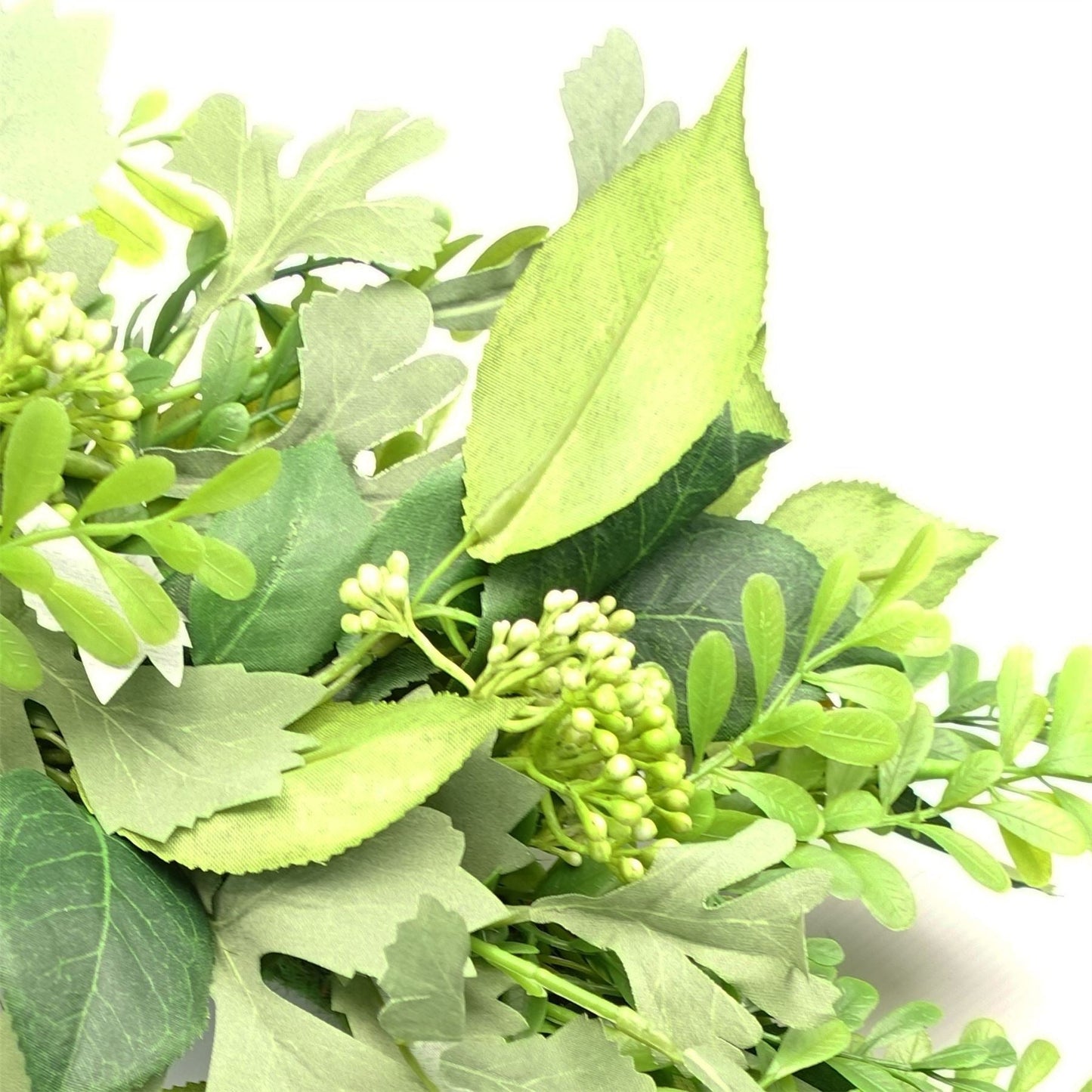 Close-up of The Fern & Fable Wreath—showing layered artificial fern foliage in soft green tones with natural woven base, styled for botanical depth and vintage countryside elegance.