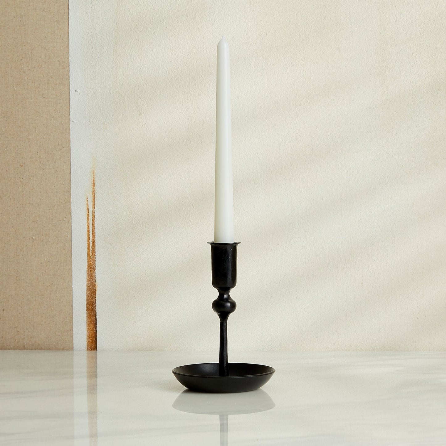 Hand-forged iron candle holder in matte black finish, rustic forge-style decor for winter mantle or festive table setting