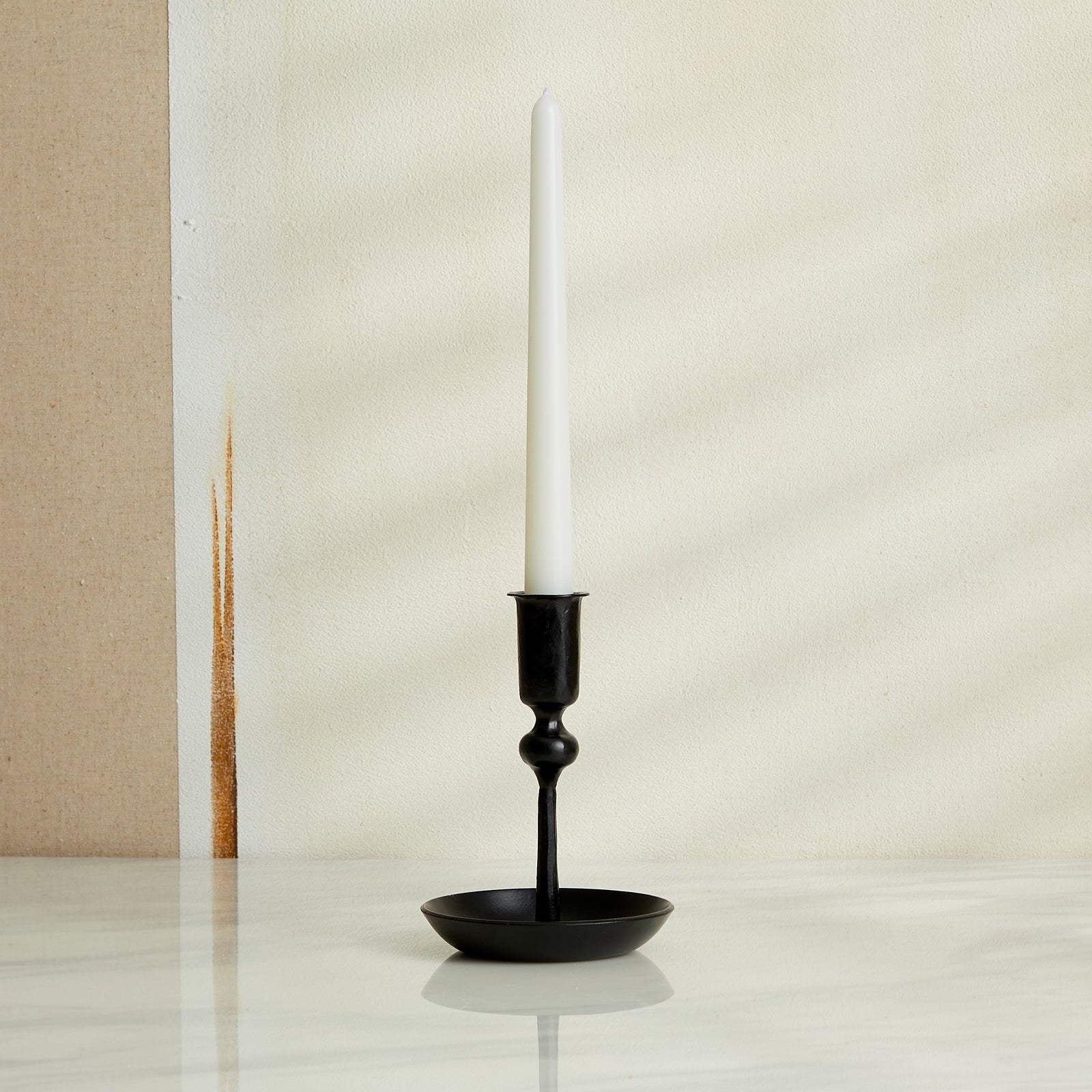 Hand-forged iron candle holder in matte black finish, rustic forge-style decor for winter mantle or festive table setting