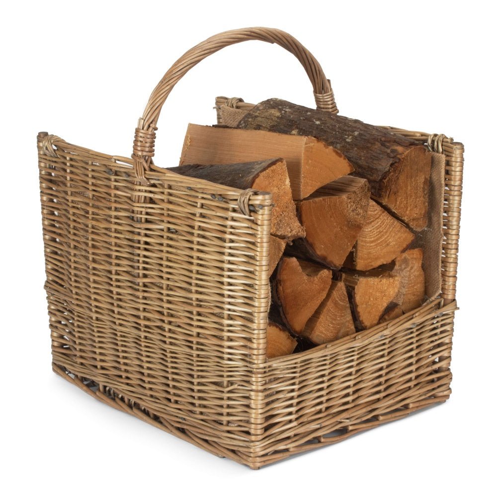 Handwoven antique wash wicker log basket filled with split firewood