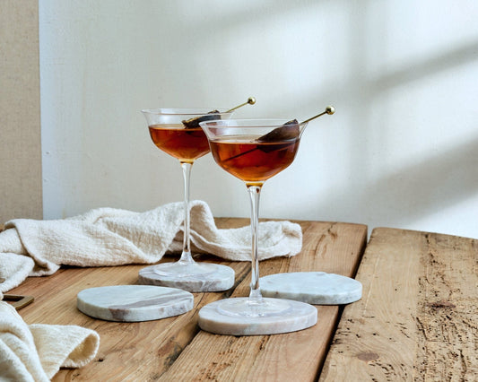 Set of handcrafted marble coasters with countryside charm, polished finish, and artisan irregular shape for soulful serving.
