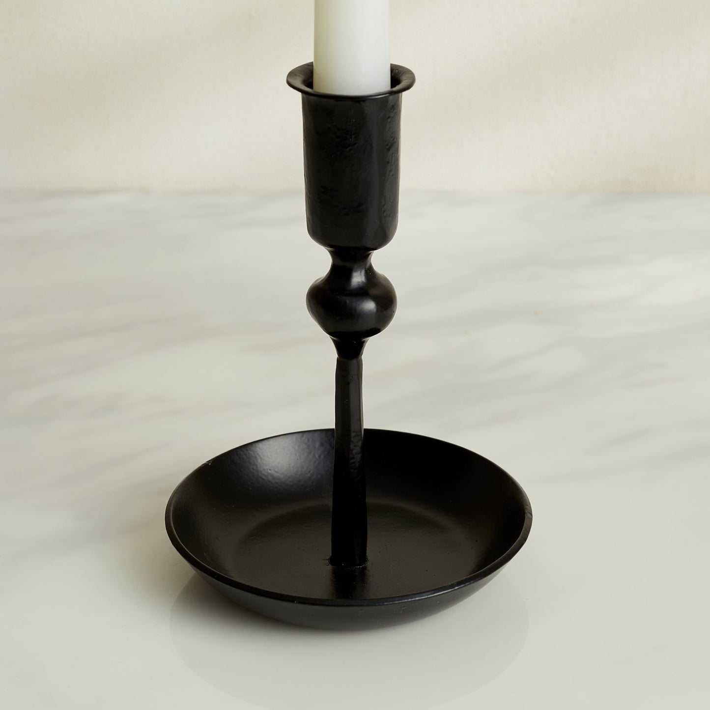 Close-up of Noa black iron candle holder with matte finish, forge-style decor for rustic mantle or winter table setting