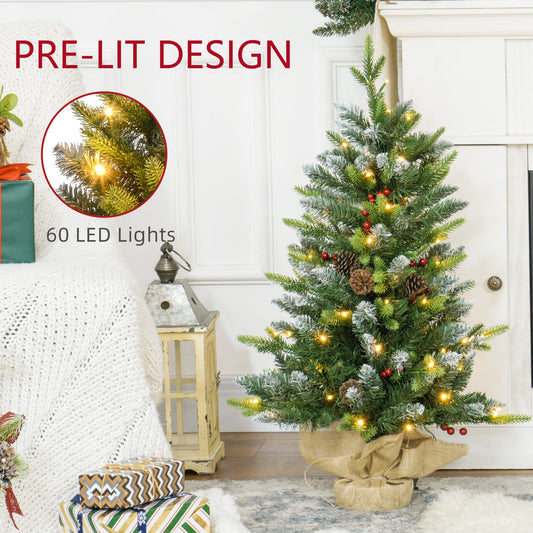 Close-up of 3ft prelit artificial Christmas tree showing 60 warm white LED lights woven through snow-brushed branches with red berries and pinecones.