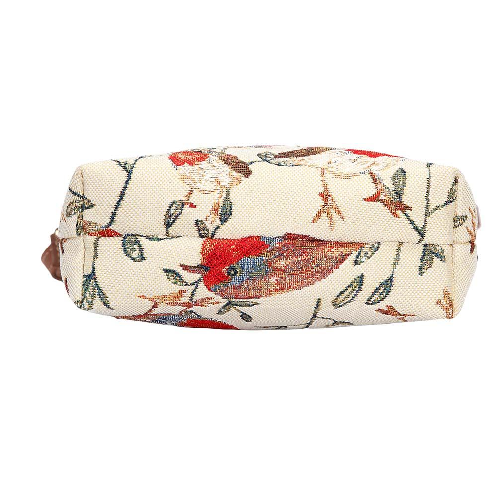Bottom view of Robin sling bag in tapestry fabric showing structured base, zip closure and vegan leather trim in warm woodland tones