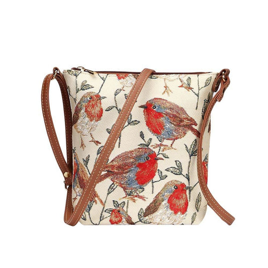 Side view of Robin sling bag in tapestry fabric with zip closure, adjustable strap and vegan leather trim in warm woodland tones