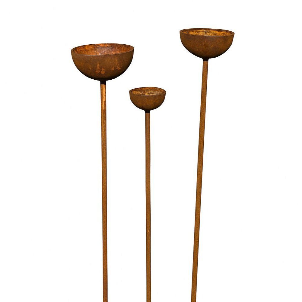 Trio of rusty rain catcher garden stakes in warm orange patina, handcrafted metal plant supports with sculptural bowls for heritage-inspired outdoor styling.