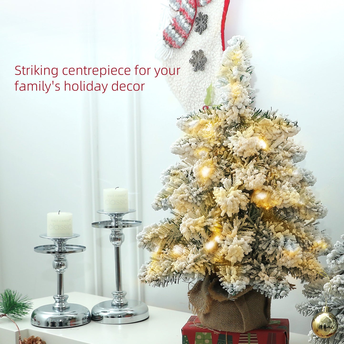 Set of two 1.5ft snow-flocked tabletop Christmas trees with warm white LED lights styled as a festive centrepiece. Linen-wrapped bases with rustic seasonal charm.