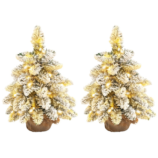 Set of two 1.5ft snow-flocked tabletop Christmas trees with warm white LED lights styled together