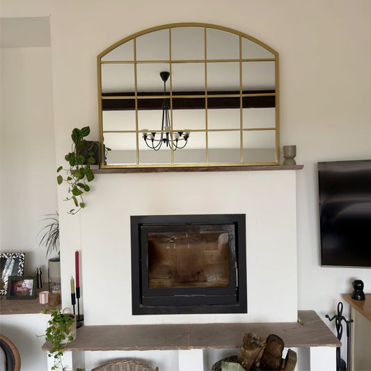 Gold arched lattice mirror — 95cm x 120cm frame inspired by Albert Dock windows, styled above a fireplace for a timeless interior