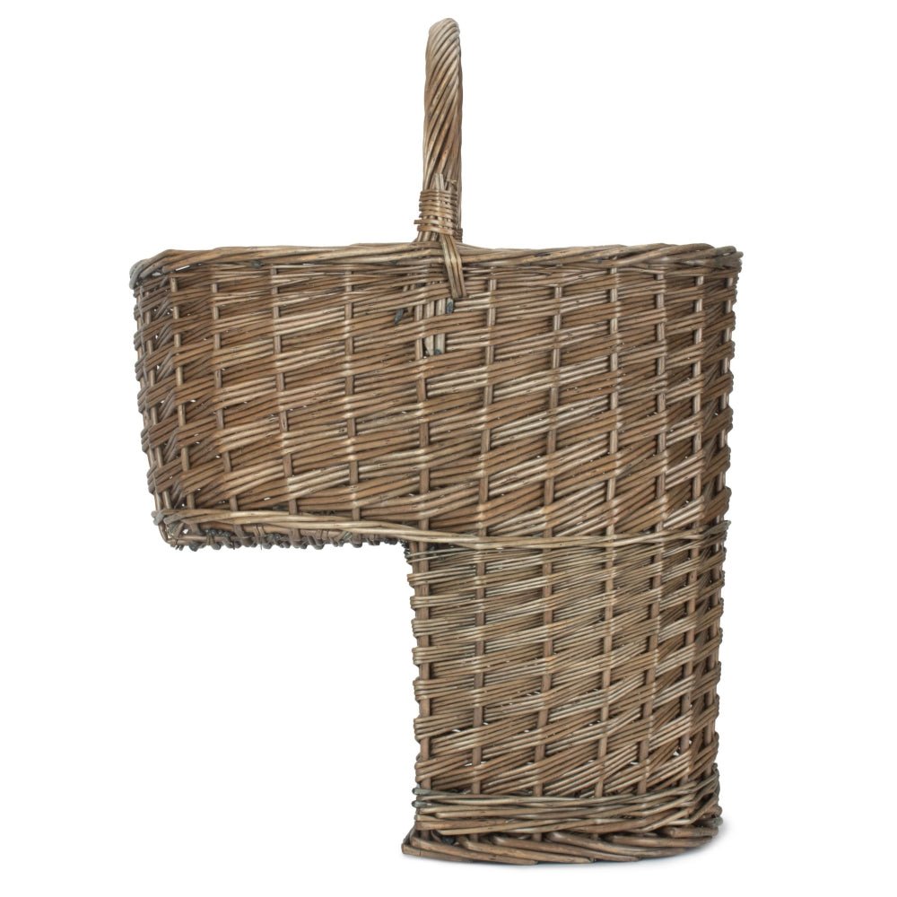 Side view of antique wash willow stair basket — unlined, curved handle and woven texture detail visible