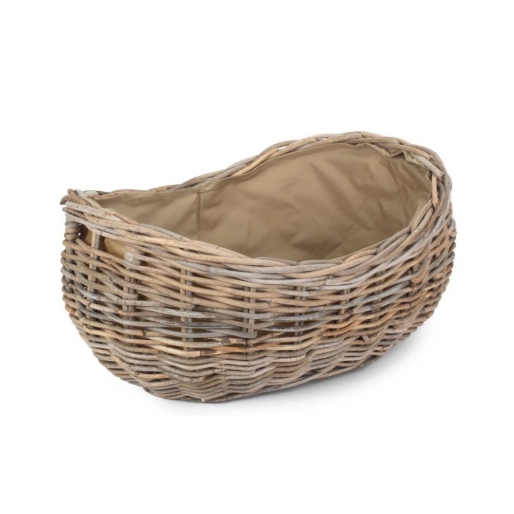 Large boat-shaped rattan log basket with Cordura lining — handwoven fireside storage inspired by coastal cottages and timeless countryside interiors