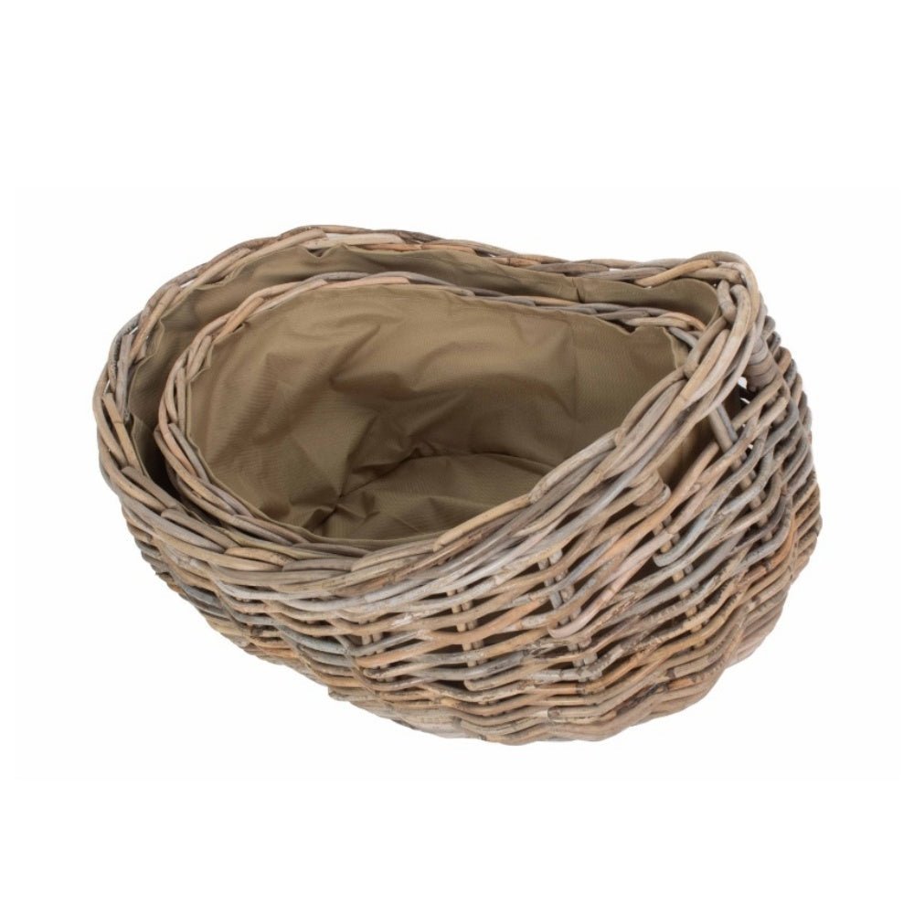 Stacked boat-shaped rattan log baskets with Cordura lining — handwoven fireside storage set inspired by coastal cottages and timeless hearth rituals