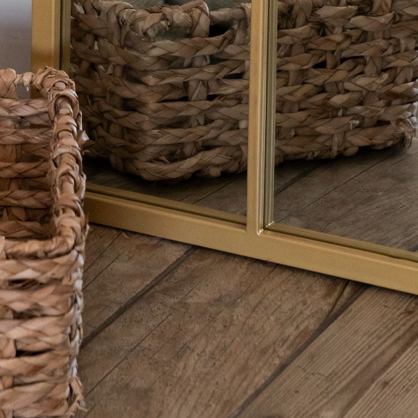 Bottom detail of gold arched lattice mirror — antique-style metal frame with soft patina and countryside-inspired charm