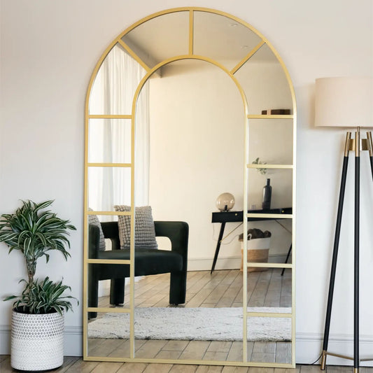 Close-up of gold arched mirror frame with lattice detailing — antique-style metal finish inspired by countryside architecture