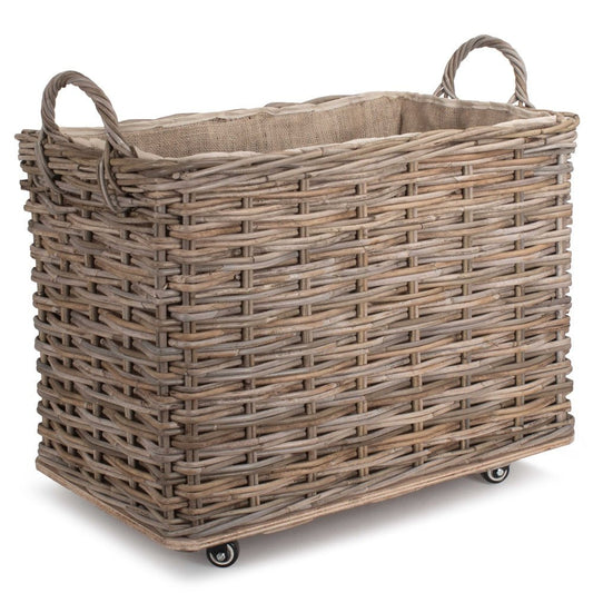 Full view of The Wainsford Log Keeper – antique wash rattan basket with hessian lining and wheels, crafted for fireside storage and countryside warmth