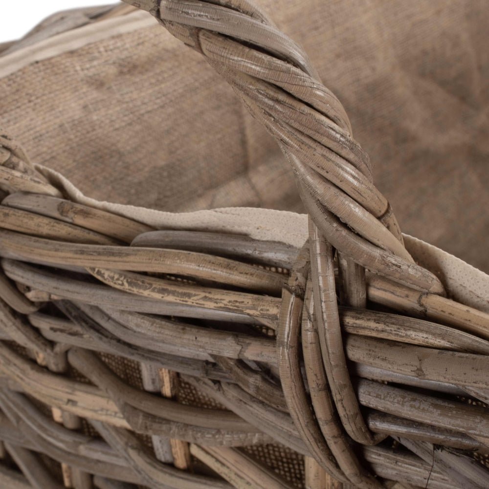 Close-up of The Wainsford Log Keeper’s curved rattan handle – antique wash weave crafted for fireside comfort and easy movement through heritage-inspired interiors