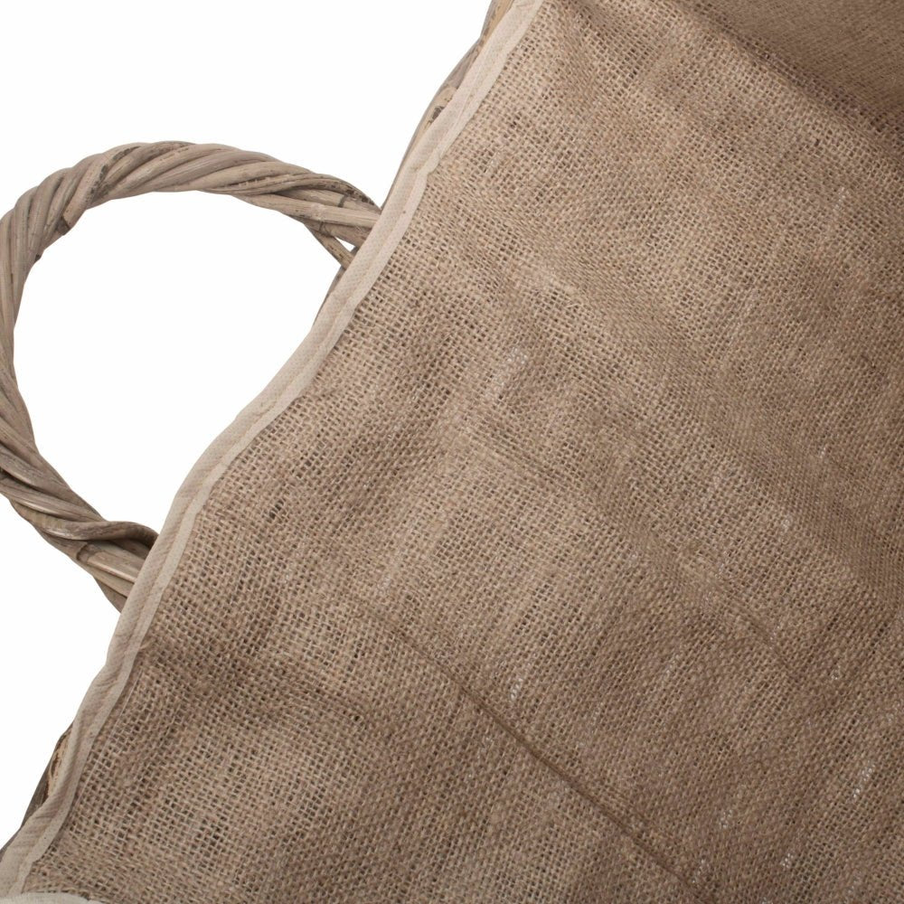 Inside view of The Wainsford Log Keeper showing deep antique wash rattan frame and soft hessian lining – wheeled fireside basket crafted for storing winter logs with timeless charm”