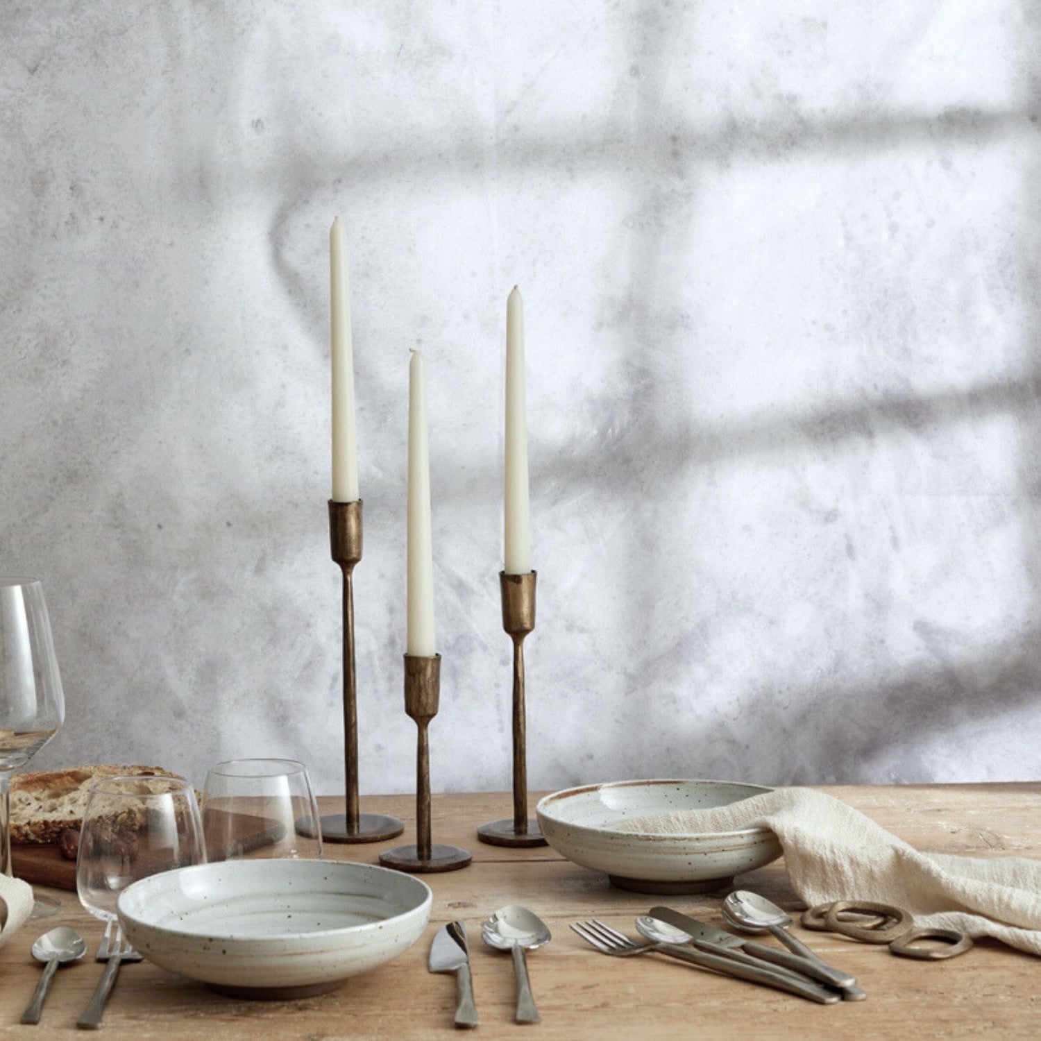 Weldon Iron Candle Holder Set – antique brass finish, styled on tabletop with natural-coloured tableware for timeless hosting and rustic elegance