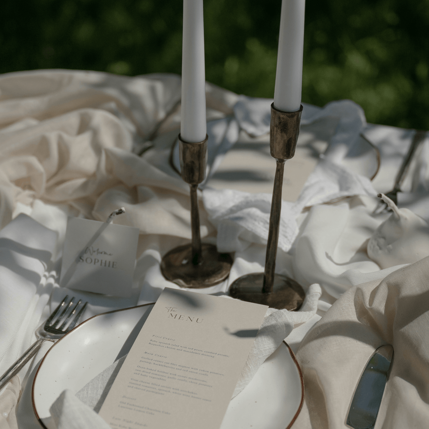 Weldon Iron Candle Holder Set – antique brass finish, styled on formal wedding table with elegant organza, place name, and menu for timeless celebration