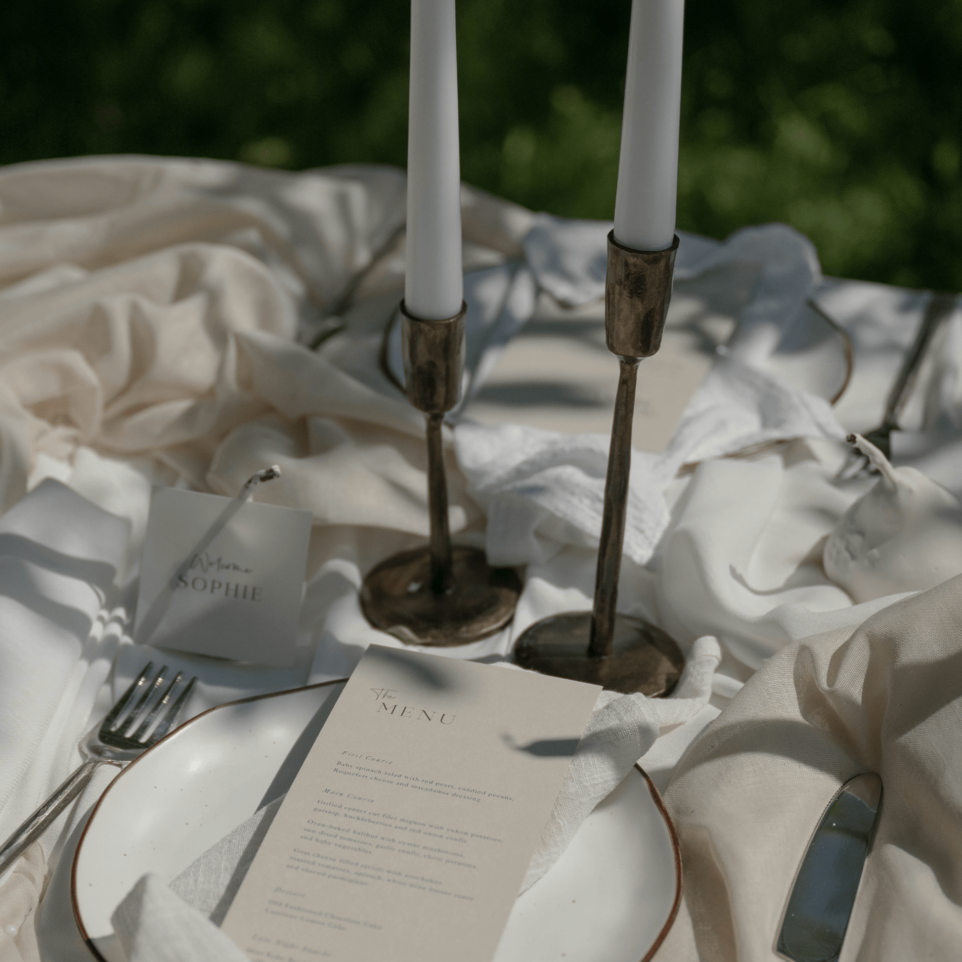 Weldon Iron Candle Holder Set – antique brass finish, styled on formal wedding table with elegant organza, place name, and menu for timeless celebration
