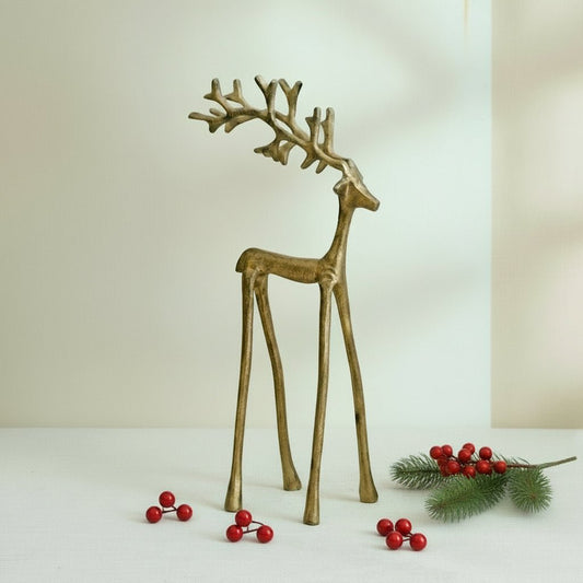 Wickham Gold Reindeer Ornament – handcrafted iron in brushed gold, styled with festive sprig and berries for mantle glow and soulful Christmas charm