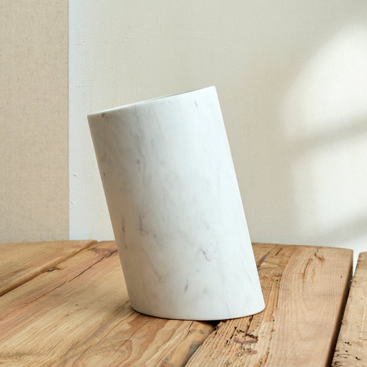 Winsford Marble Wine Holder – handcrafted white marble with natural veining, styled on rustic wood tabletop for fireside hosting and sculptural elegance
