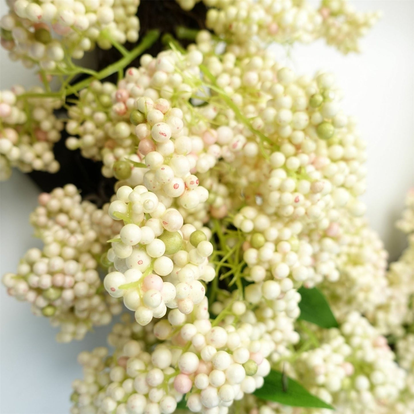 Close-up of Winterberry wreath showing white berries and soft foliage, crafted for festive styling and countryside-inspired decor