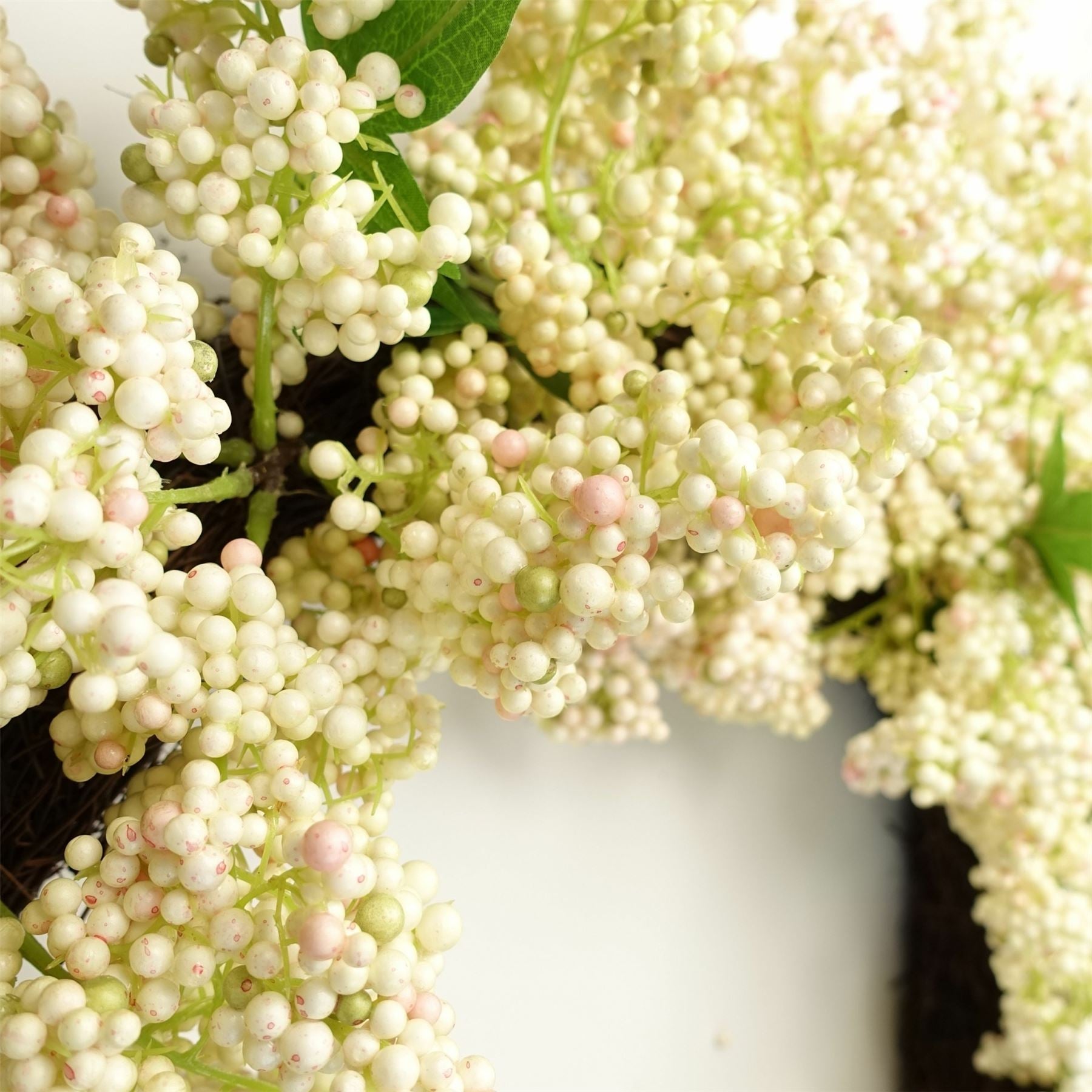Close-up of Winterberry wreath showing clustered white berries with soft foliage, crafted for festive styling and timeless seasonal decor
