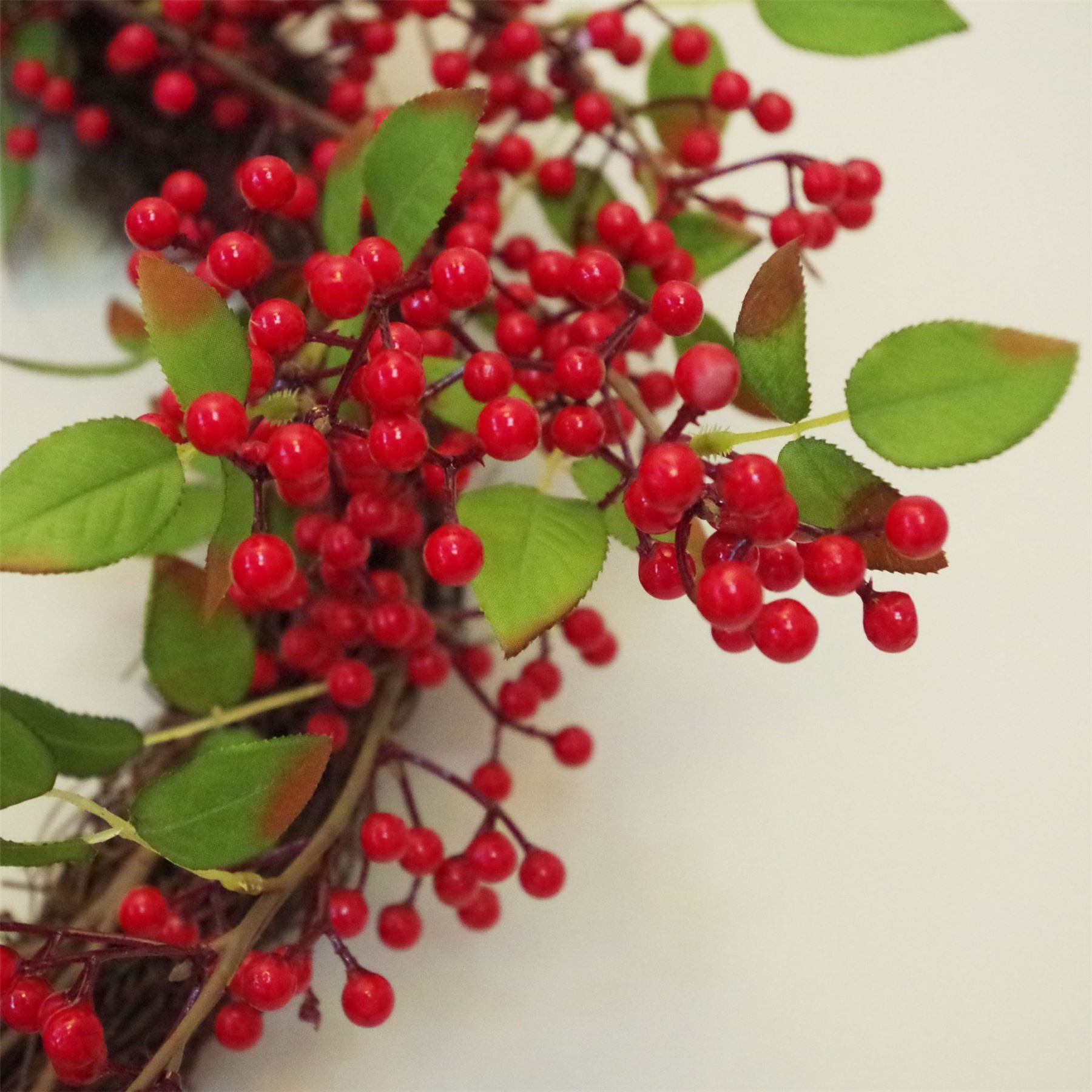 Close-up of The Winthrop wreath edge, 24 inch festive decor with heritage redberries, layered rustic foliage and natural seasonal textures