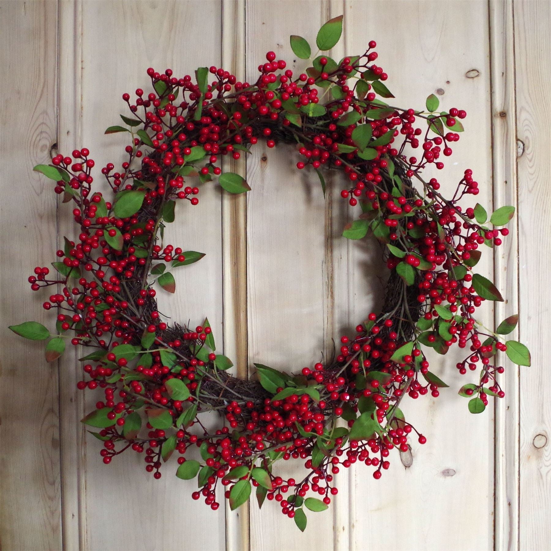 The Winthrop redberry wreath on rustic door, 24 inch round festive styling with heritage foliage and snow-kissed seasonal tones