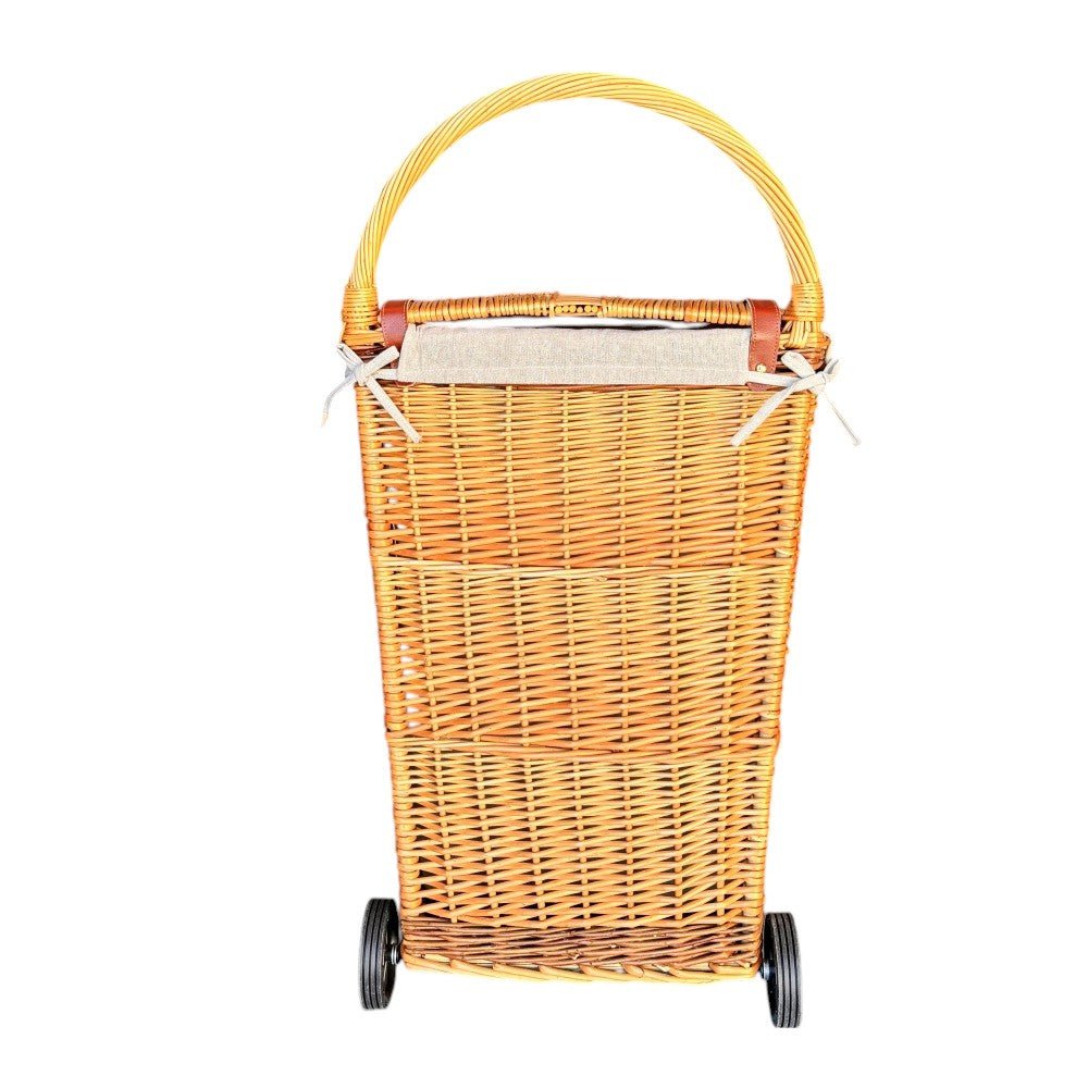 Rear view of The Malbury Market Trolley — showcasing full buff willow weave, upright silhouette, and metal wheel frame for timeless market errands and rustic storage.