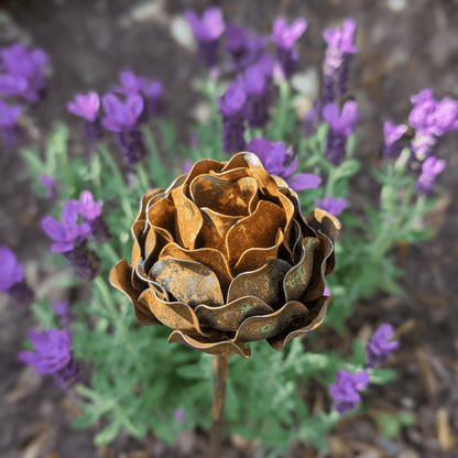 Artisan-crafted rusted metal peony garden stake with layered petals and sculptural detail, styled in a heritage-inspired UK garden setting