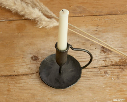 Ashford iron candle holder hand forged taper holder viewed from above on wooden table top
