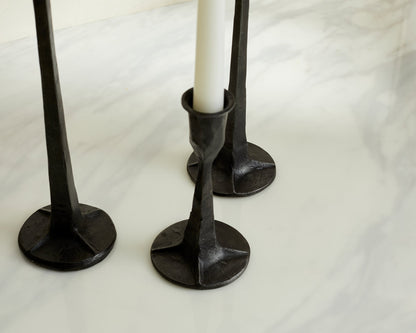 Close view of Bloomsbury Iron Black Candle Holder Set of 3 displayed on a table